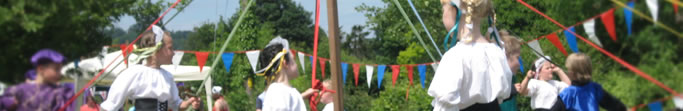 photo of children dancing around a maypole